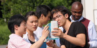 A group of international students talk to each other.